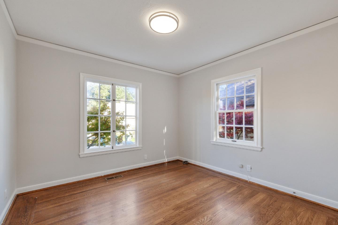 414 Williams Place San Mateo, CA 94401 - Photo 13 of 32 an empty room with wooden floor and windows