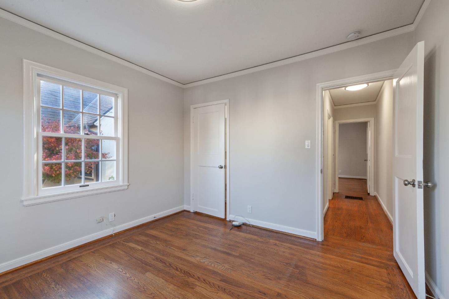 414 Williams Place San Mateo, CA 94401 - Photo 15 of 32 an empty room with wooden floor and windows