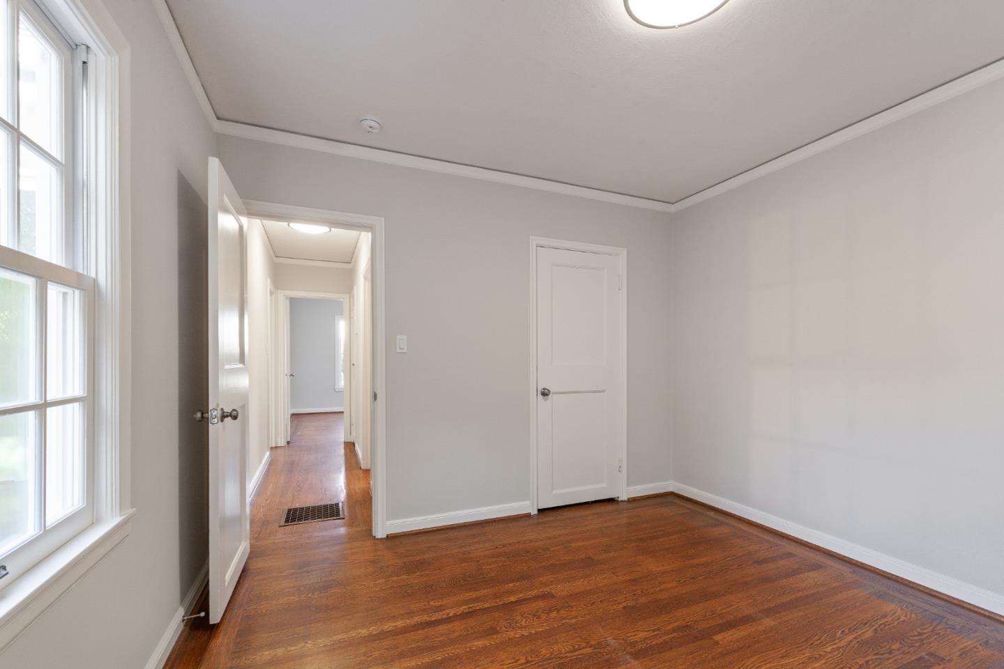 414 Williams Place San Mateo, CA 94401 - Photo 17 of 32 a view of an empty room with wooden floor and a window