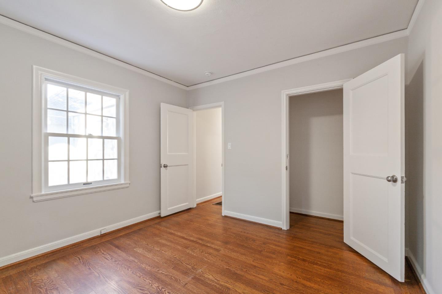 414 Williams Place San Mateo, CA 94401 - Photo 18 of 32 an empty room with wooden floor and windows