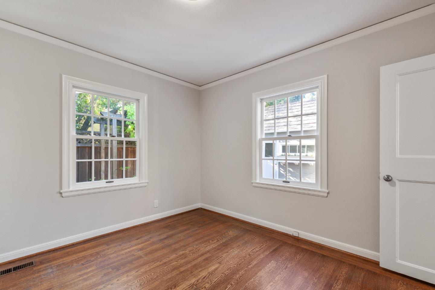 414 Williams Place San Mateo, CA 94401 - Photo 19 of 32 an empty room with wooden floor and windows