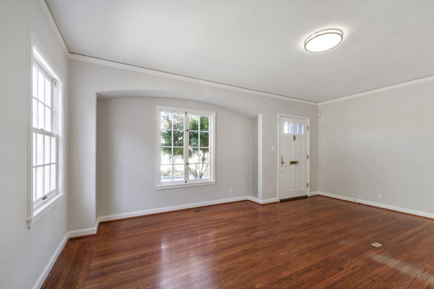 414 Williams Place San Mateo, CA 94401 - Photo 6 of 32 an empty room with wooden floor and windows