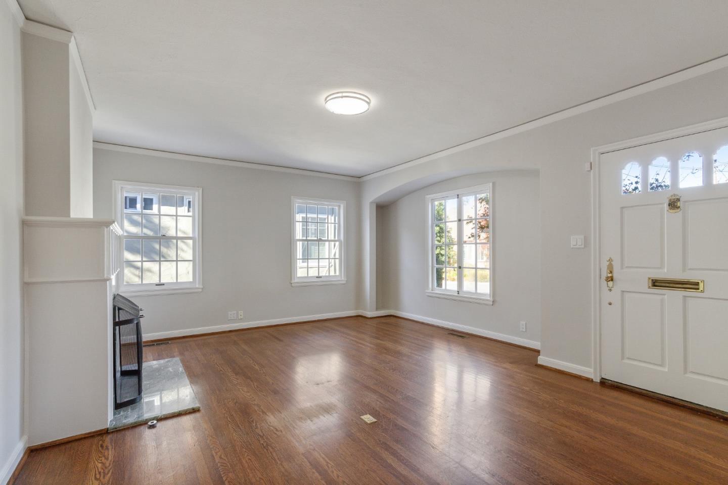 414 Williams Place San Mateo, CA 94401 - Photo 7 of 32 an empty room with wooden floor and windows with curtains view