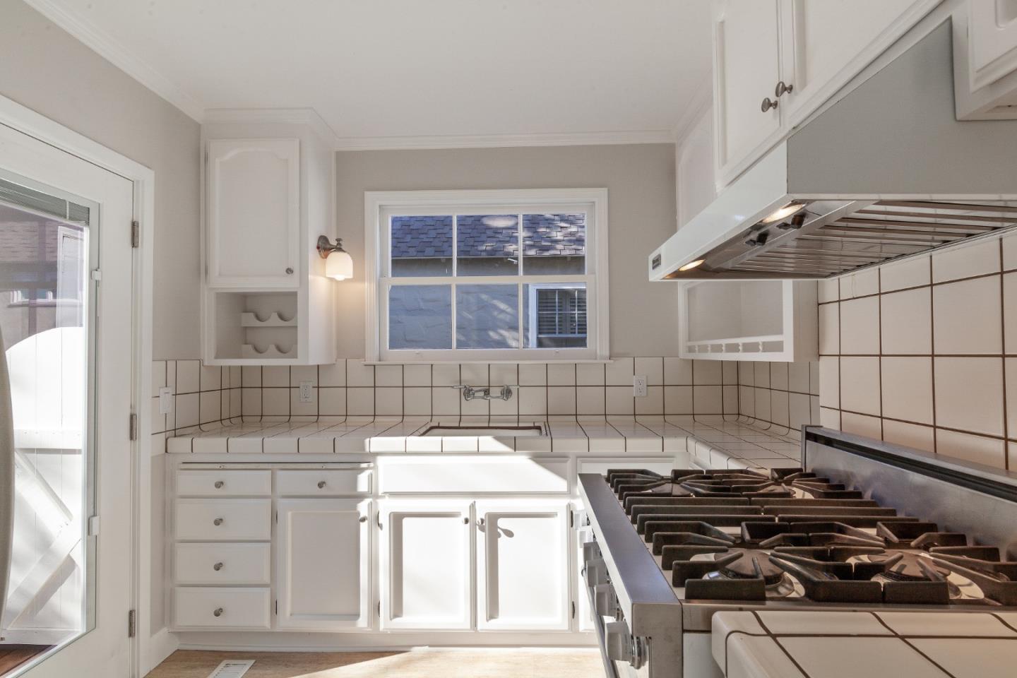 414 Williams Place San Mateo, CA 94401 - Photo 10 of 32 a kitchen that has a stove and a wooden cabinets