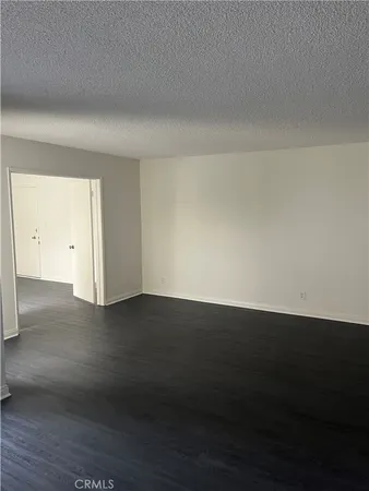 a view of an empty room and wooden floor