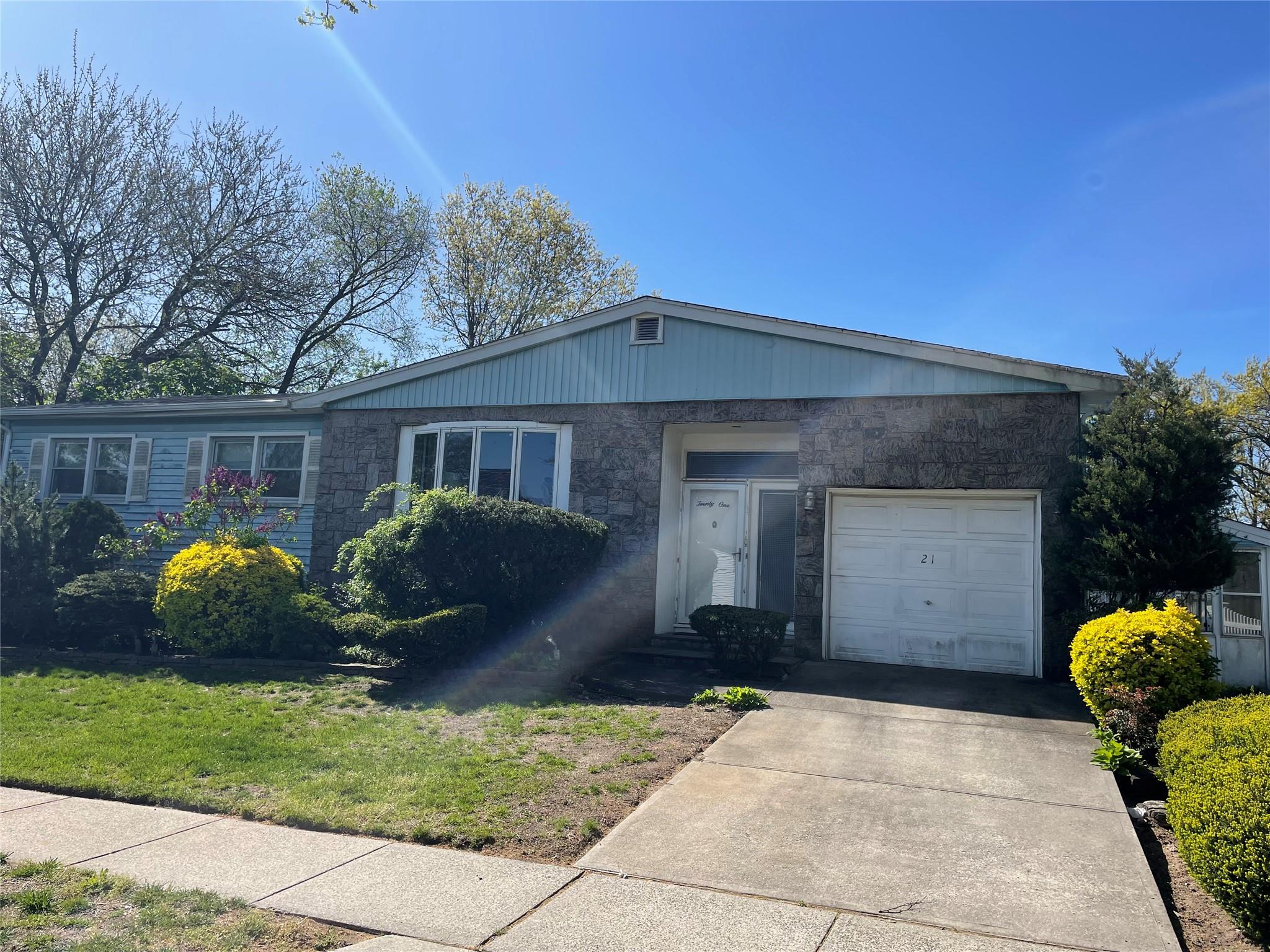 21 Flower Road Valley Stream, NY 11581 - Photo 1 of 1 a front view of house with a garden