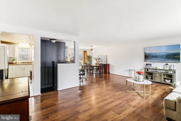 a living room with furniture and a kitchen view