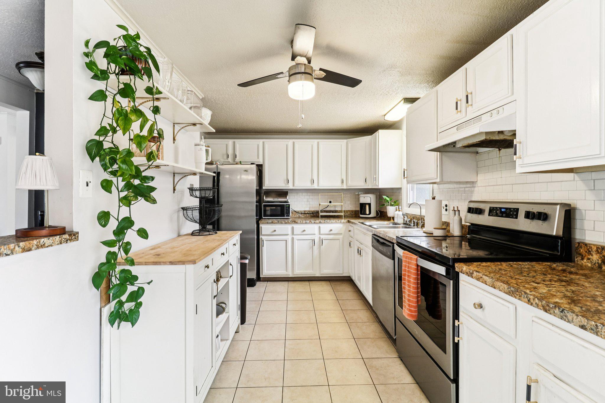 14617 Livingston Road Accokeek, MD 20607 - Photo 14 of 53 a kitchen with stainless steel appliances a sink and a refrigerator