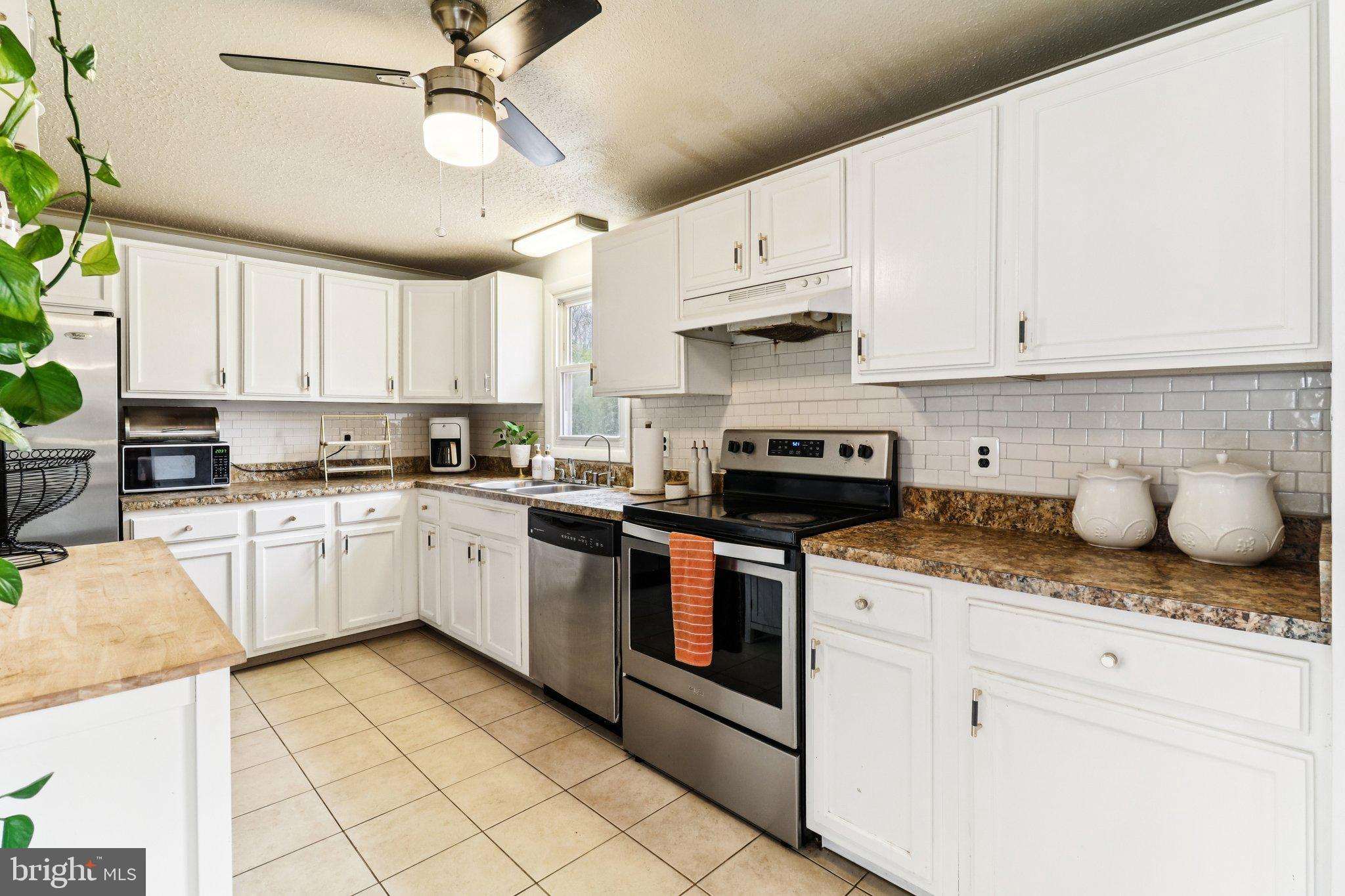 14617 Livingston Road Accokeek, MD 20607 - Photo 15 of 53 a kitchen with granite countertop white cabinets and white appliances