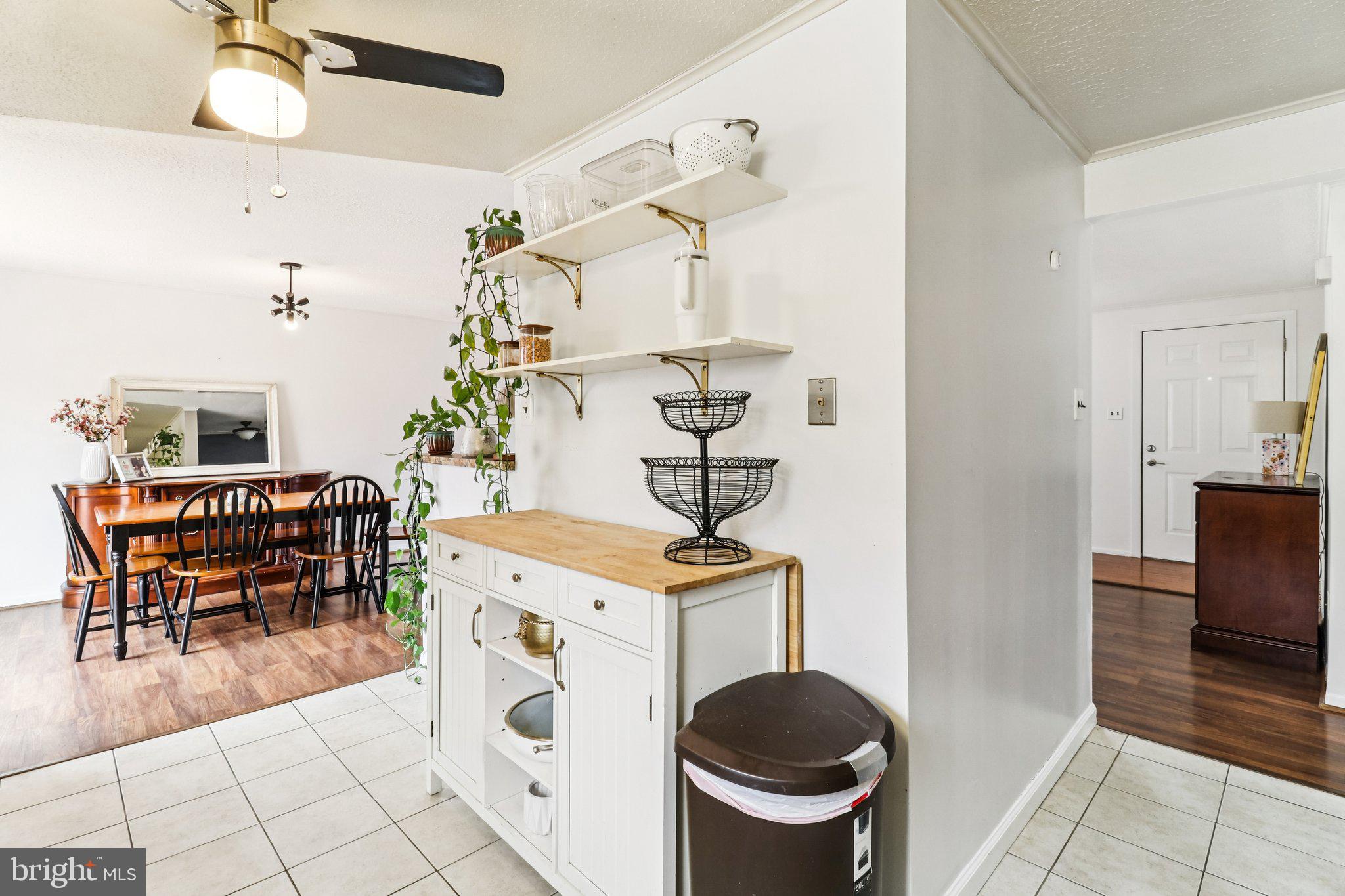 14617 Livingston Road Accokeek, MD 20607 - Photo 16 of 53 a dining hall with a stove a dining table and chairs with wooden floor