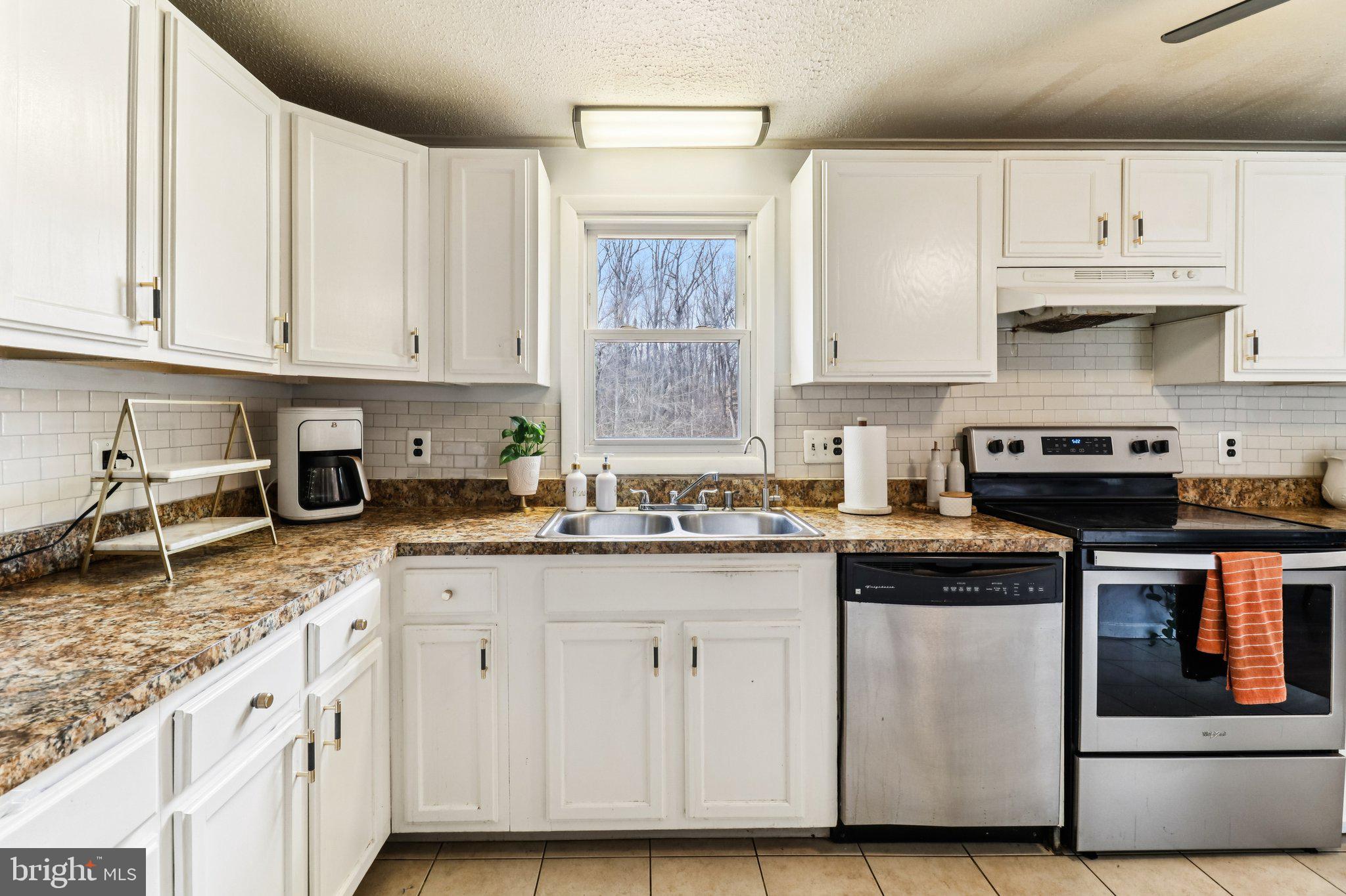 14617 Livingston Road Accokeek, MD 20607 - Photo 17 of 53 a kitchen with cabinets appliances a sink and a counter top space