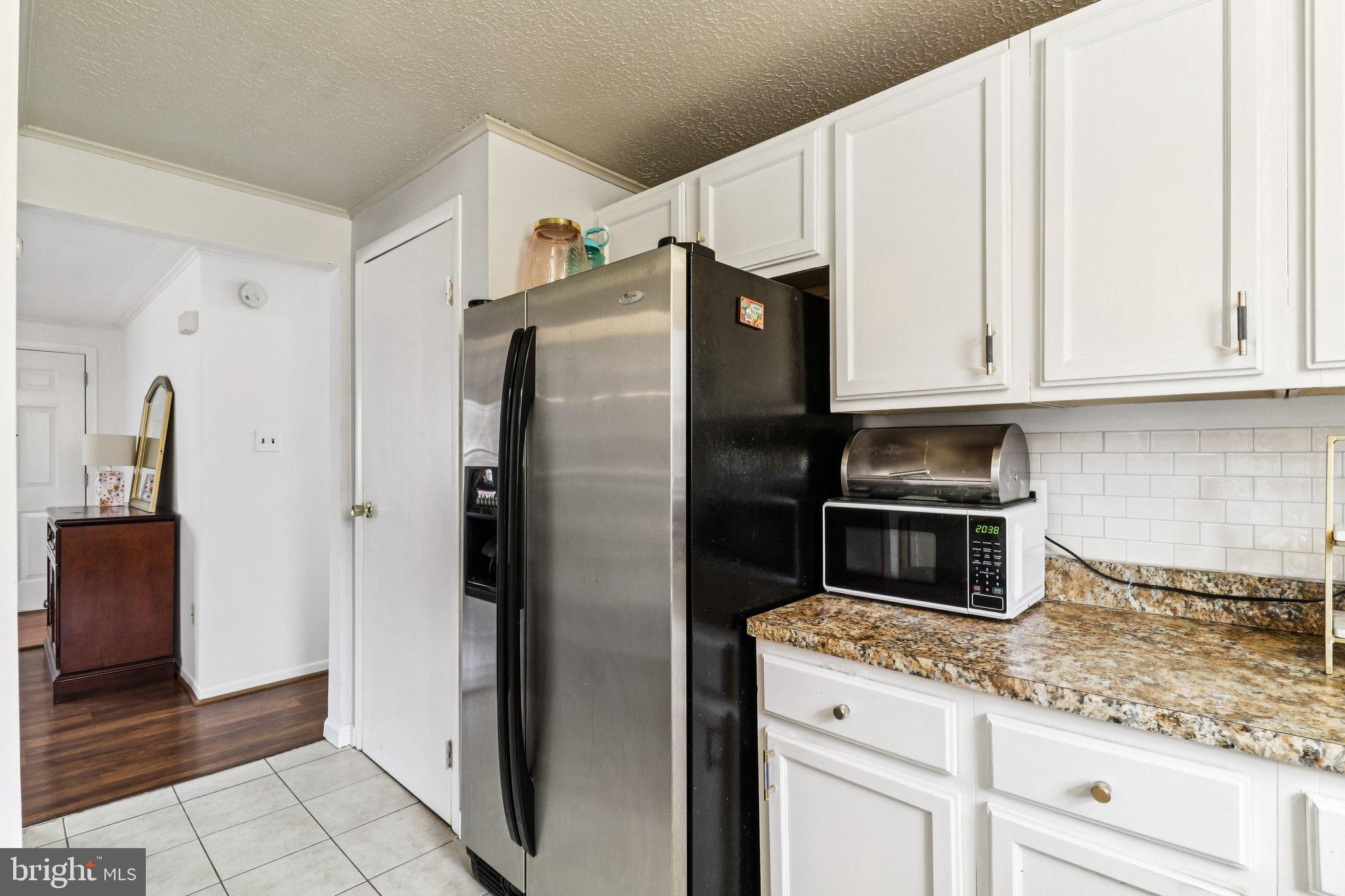 14617 Livingston Road Accokeek, MD 20607 - Photo 18 of 53 a kitchen with stainless steel appliances granite countertop a refrigerator and a stove top oven