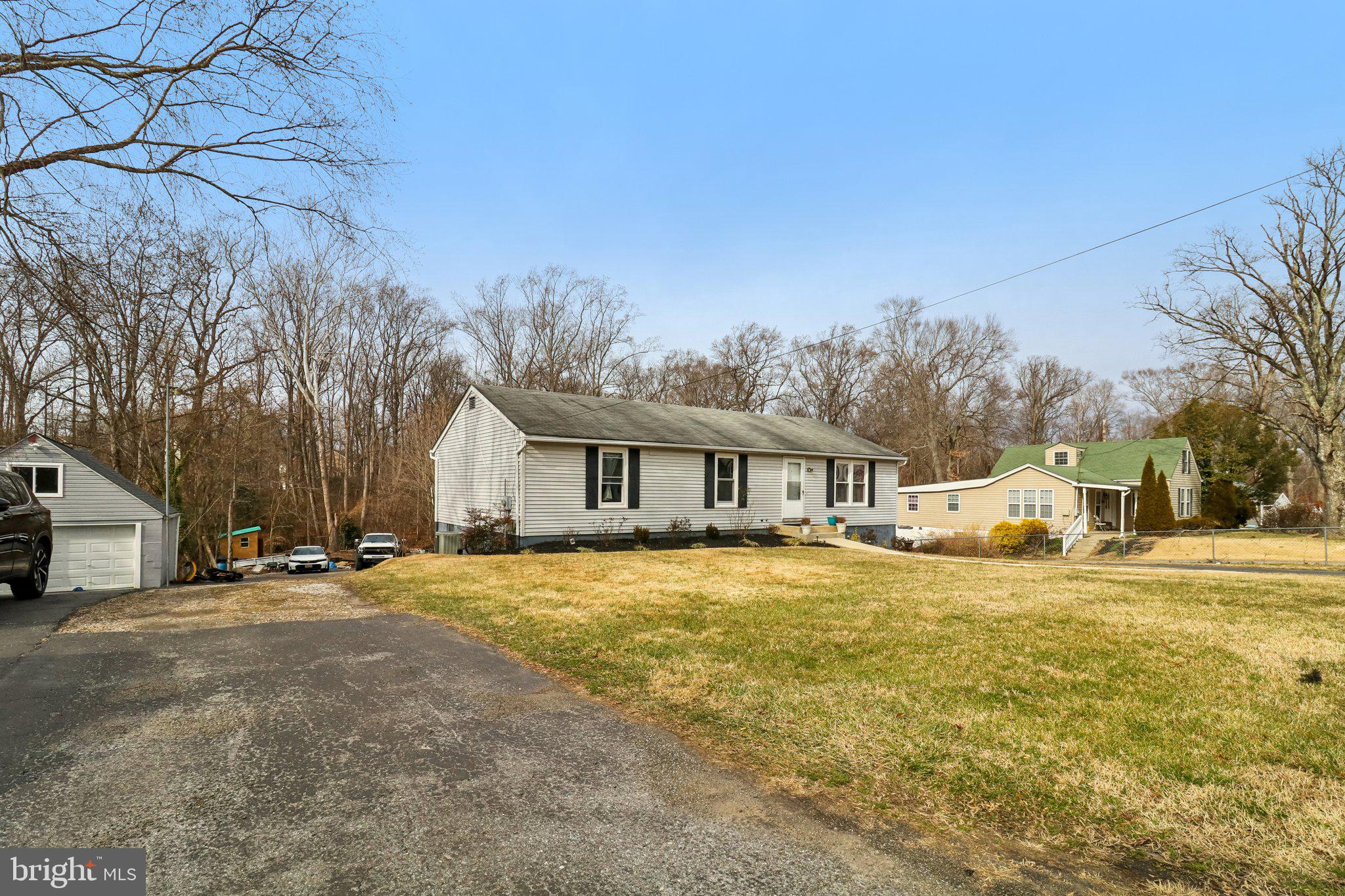 14617 Livingston Road Accokeek, MD 20607 - Photo 2 of 53 a yellow house with trees in front of it