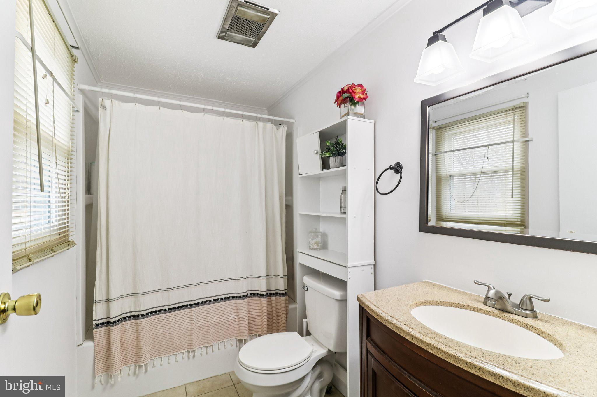 14617 Livingston Road Accokeek, MD 20607 - Photo 27 of 53 a bathroom with a sink vanity mirror and toilet