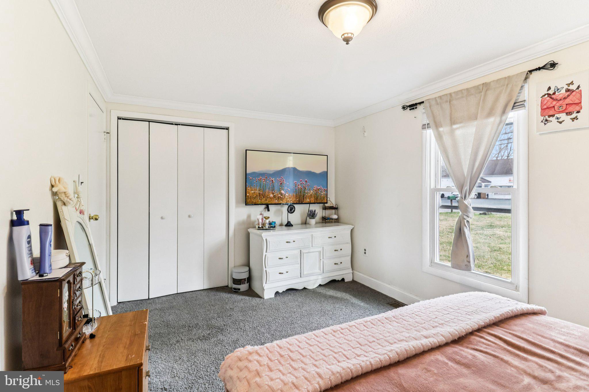 14617 Livingston Road Accokeek, MD 20607 - Photo 32 of 53 a bedroom with a bed and a flat screen tv