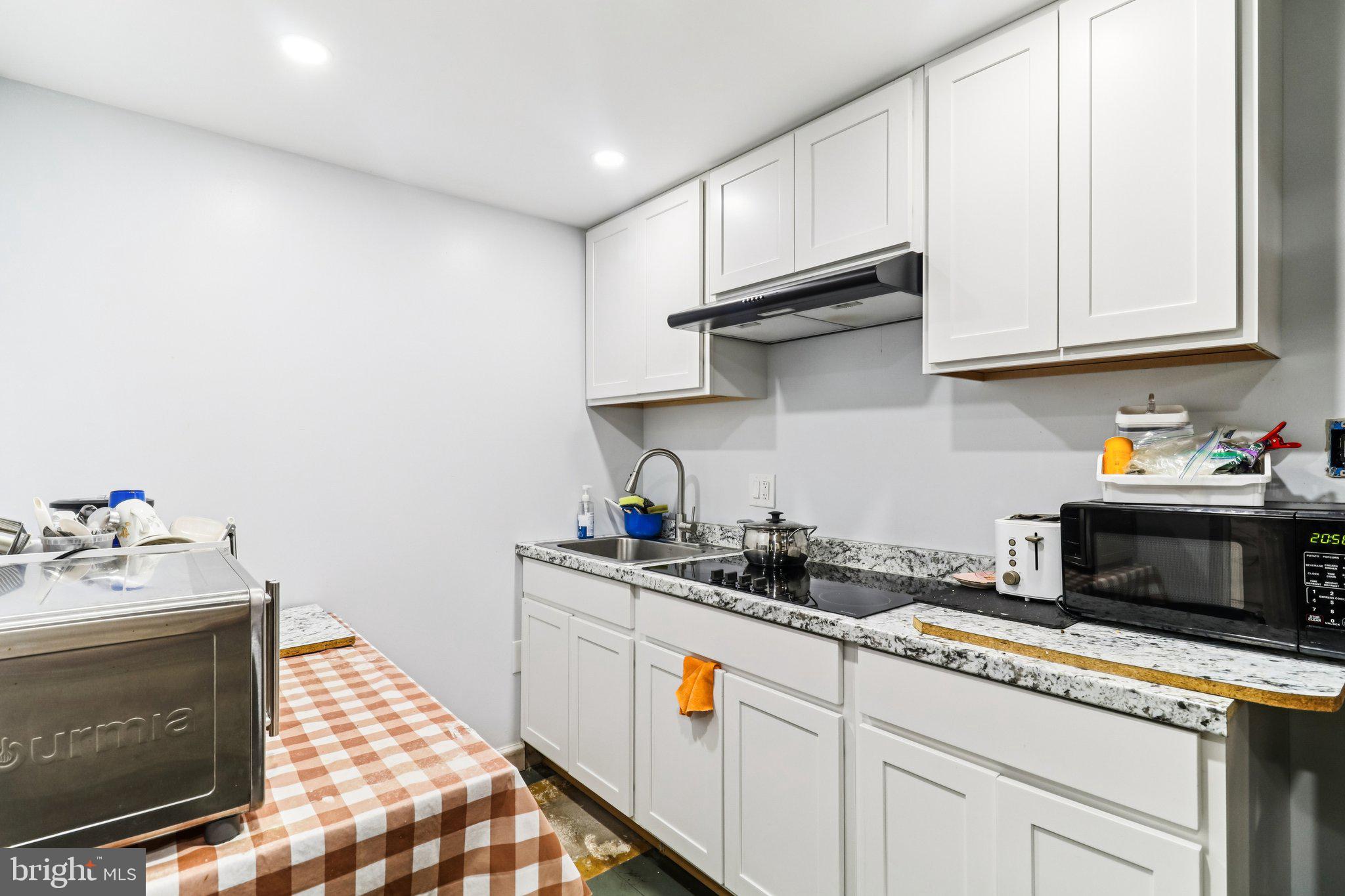 14617 Livingston Road Accokeek, MD 20607 - Photo 40 of 53 a kitchen with stainless steel appliances granite countertop a sink stove and cabinets