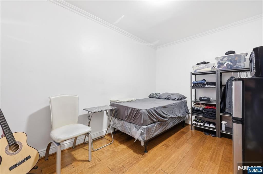 409 Tryon Avenue Englewood, NJ 07631 - Photo 15 of 33 a bedroom with a bed and a chair