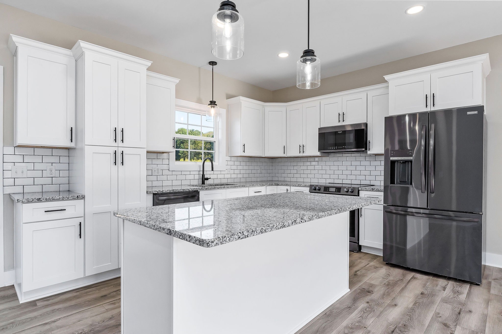 912 Frank Anderson Road Sparta, TN 38583 - Photo 12 of 28 a kitchen with stainless steel appliances granite countertop a refrigerator a sink a stove a microwave and wooden floors