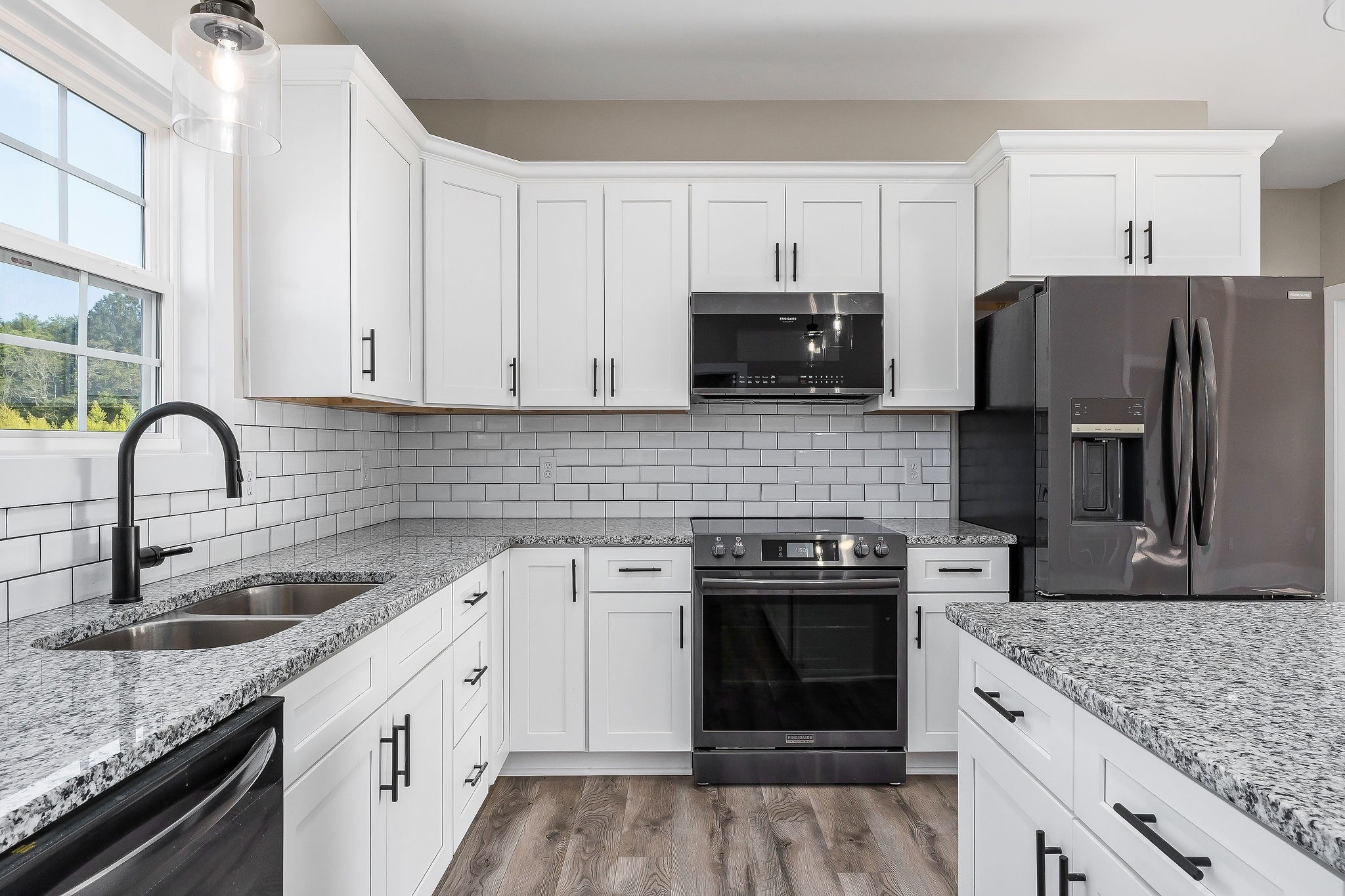 912 Frank Anderson Road Sparta, TN 38583 - Photo 13 of 28 a kitchen with white cabinets and stainless steel appliances