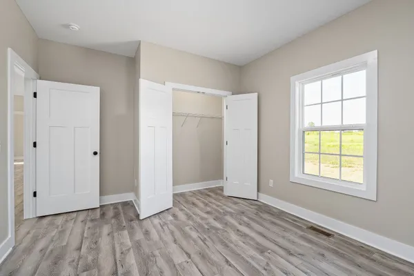 a bathroom with a granite countertop sink a large mirror and a refrigerator