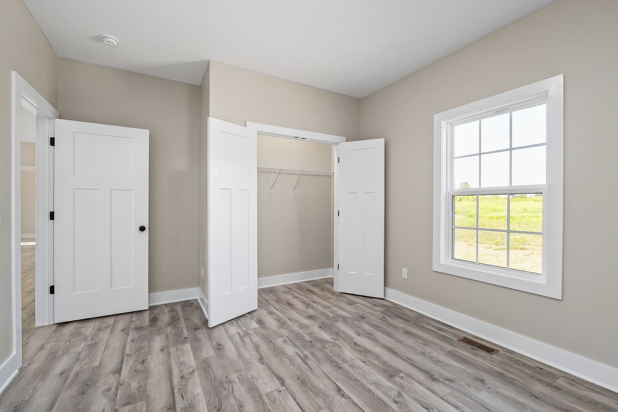 912 Frank Anderson Road Sparta, TN 38583 - Photo 15 of 28 a view of an empty room with wooden floor and a window