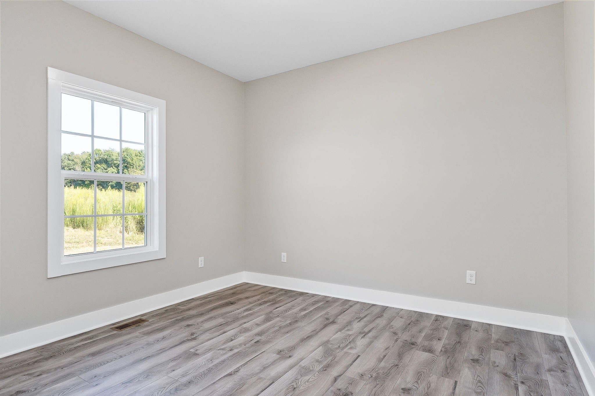 912 Frank Anderson Road Sparta, TN 38583 - Photo 16 of 28 an empty room with wooden floor and windows
