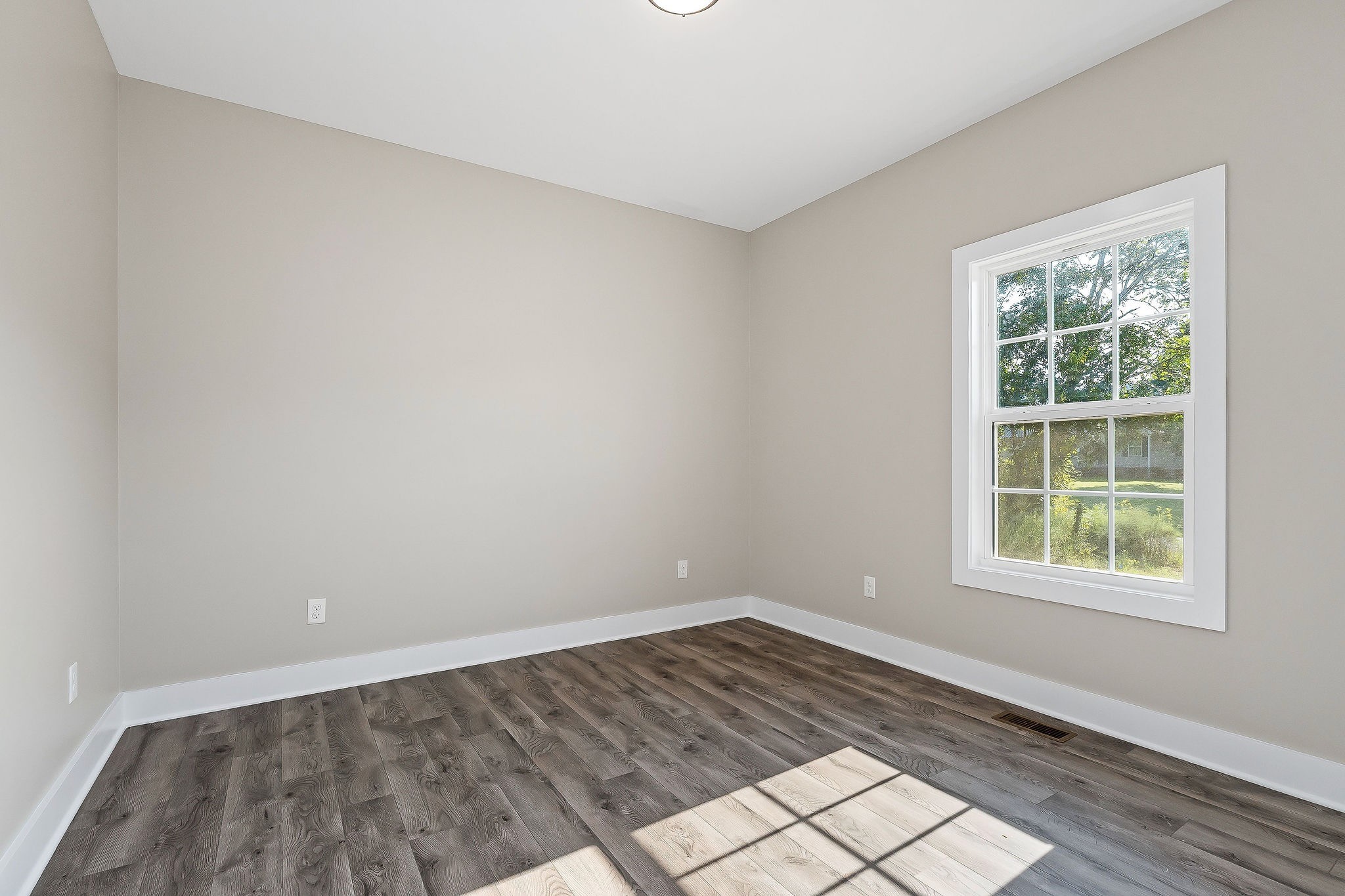 912 Frank Anderson Road Sparta, TN 38583 - Photo 18 of 28 an empty room with wooden floor and windows
