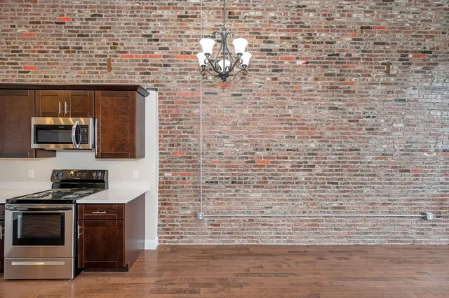 a kitchen with stainless steel appliances a stove and a sink