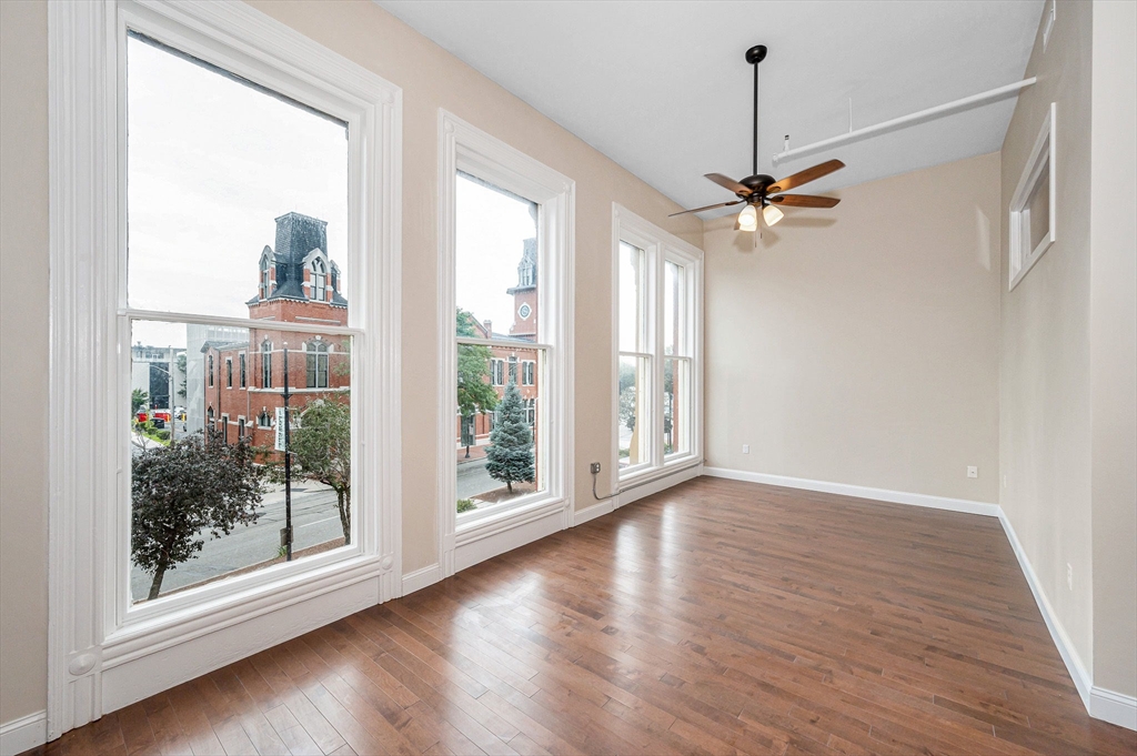 231 Central Street, Unit 203 Lowell, MA 01852 - Photo 14 of 15 a view of a livingroom with furniture wooden floor and a chandelier