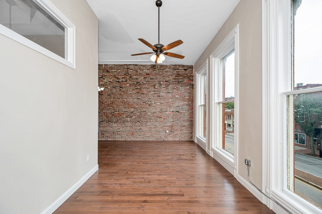 231 Central Street, Unit 203 Lowell, MA 01852 - Photo 15 of 15 a view of a livingroom with a ceiling fan and window