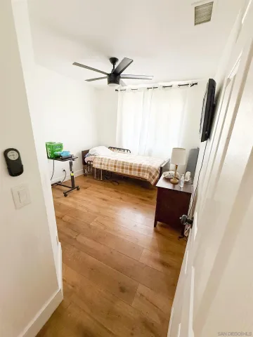 a view of a room with wooden floor and furniture