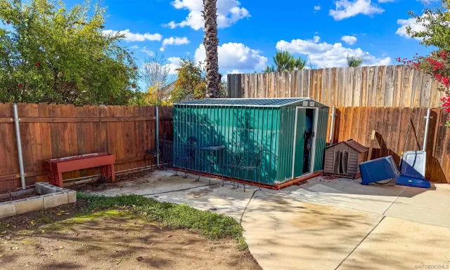 a backyard of a house with table and chairs