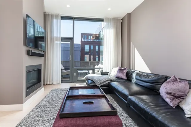 a living room with furniture fireplace and flat screen tv