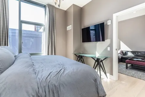 a bed sitting in a bedroom next to a window