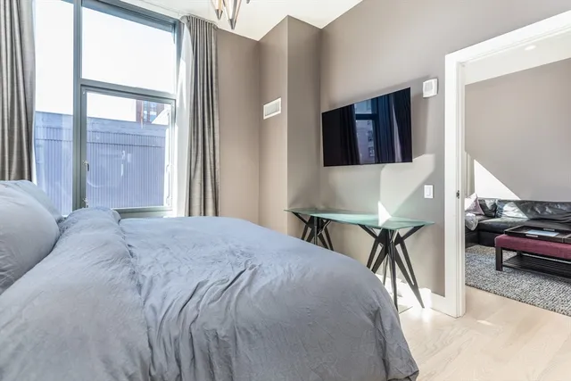 a bed sitting in a bedroom next to a window