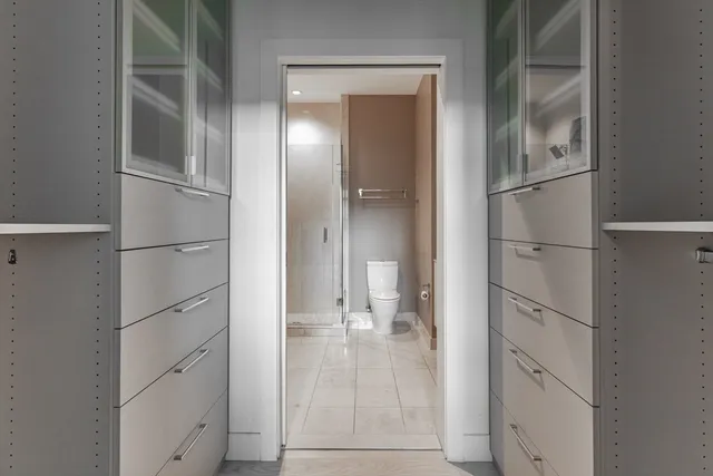 a view of walk in closet with empty racks