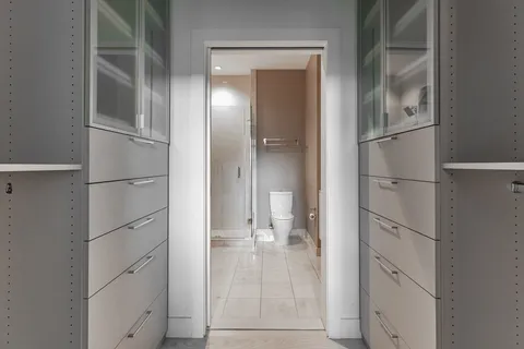 a bathroom with a granite countertop sink a toilet and shower