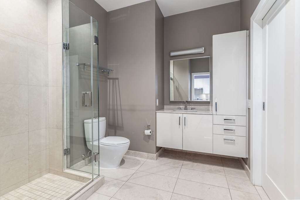 32 Traveler Street, Unit PH8 Boston, MA 02118 - Photo 17 of 38 a bathroom with a toilet sink and mirror