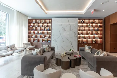 a living room with furniture and a chandelier