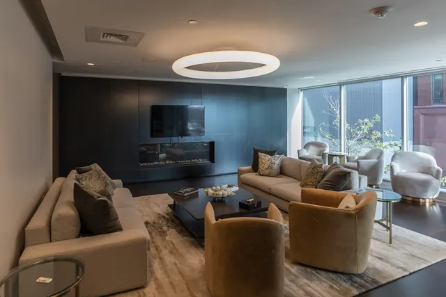 a living room with furniture and a chandelier