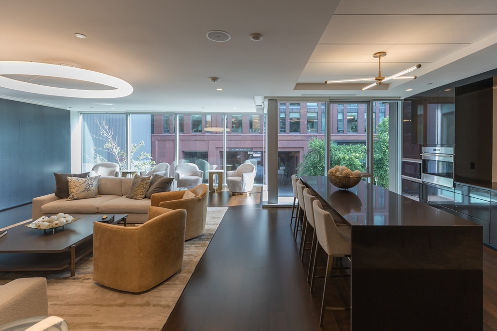32 Traveler Street, Unit PH8 Boston, MA 02118 - Photo 25 of 38 a living room with furniture and a chandelier