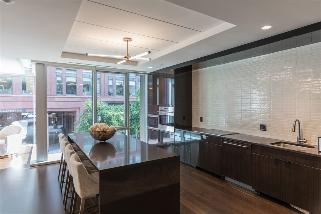 32 Traveler Street, Unit PH8 Boston, MA 02118 - Photo 26 of 38 a kitchen with a sink and wooden cabinets