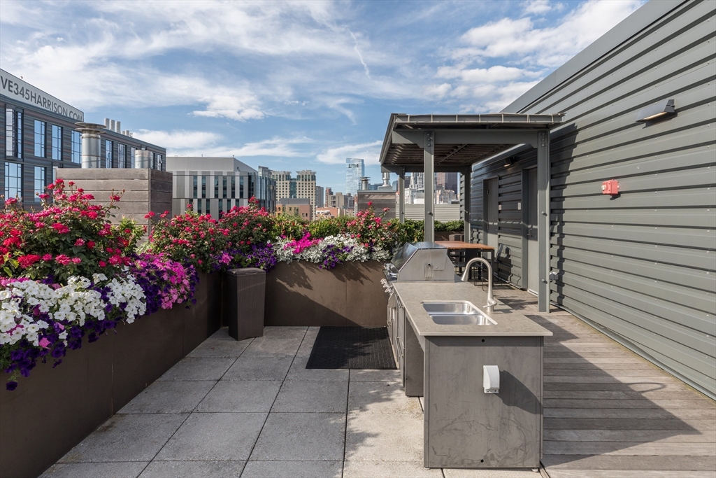 32 Traveler Street, Unit PH8 Boston, MA 02118 - Photo 29 of 38 a view of a patio with table and chairs and potted plants
