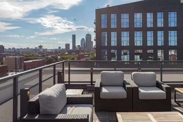 a view of a chairs and tables in patio with potted plants