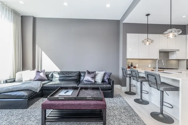 a kitchen with stainless steel appliances kitchen island granite countertop a stove a sink and a refrigerator