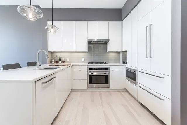 a kitchen with a stove oven and white cabinets