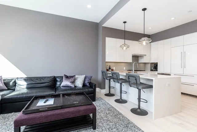 a kitchen with a table chairs a stove and a window