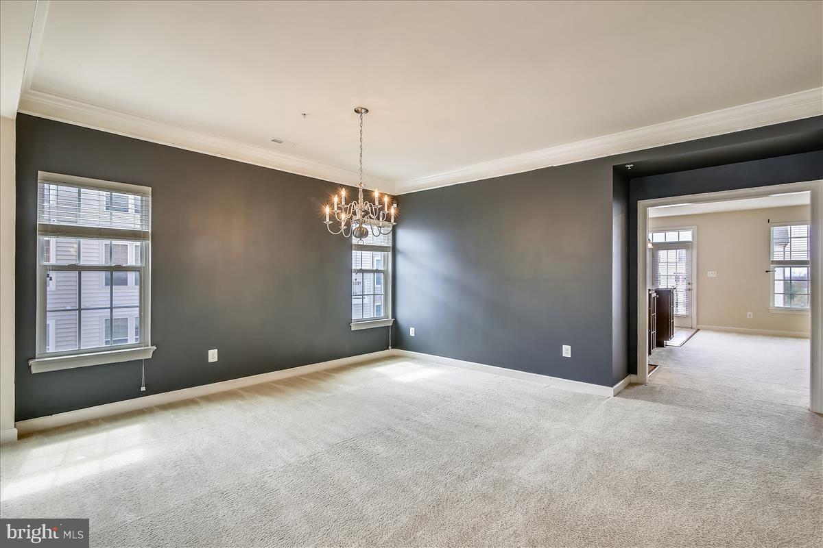 3602 Spring Hollow Lane Frederick, MD 21704 - Photo 13 of 25 a view of an empty room with chandelier and window