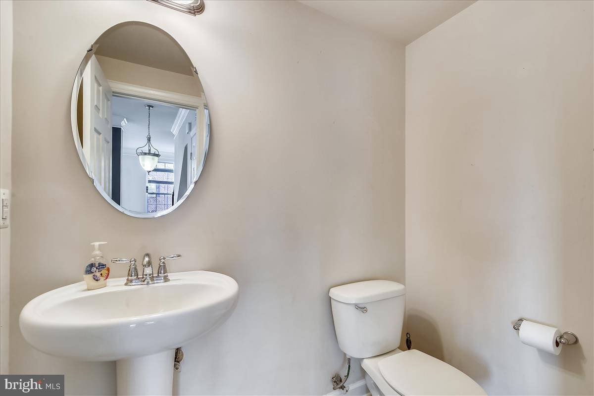 3602 Spring Hollow Lane Frederick, MD 21704 - Photo 14 of 25 a bathroom with a toilet sink and mirror