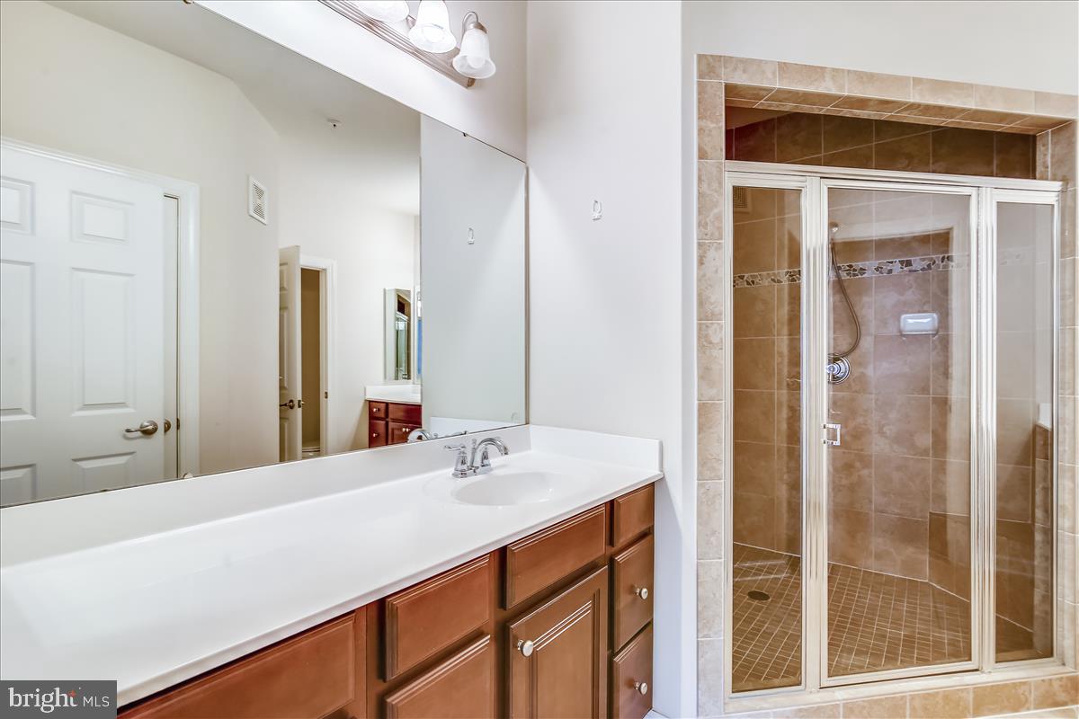 3602 Spring Hollow Lane Frederick, MD 21704 - Photo 17 of 25 a bathroom with a double vanity sink mirror and shower
